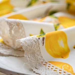 White linen tablecloth with lemon print and vintage crochet lace border detail