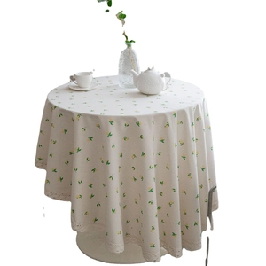 Round table cloth with yellow lemon print and white lace edges for dining decor