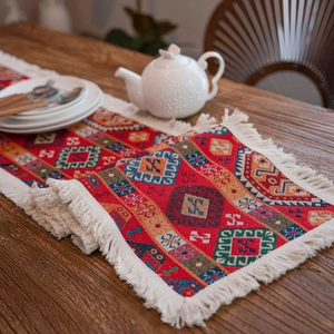Red bohemian table runner with geometric jacquard patterns and cotton tassels decor