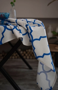 Close-up of blue geometric clover pattern on premium cotton linen tablecloth fabric