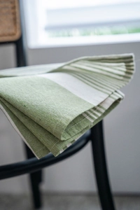 Detail of green and white striped cotton linen fabric with high quality woven texture