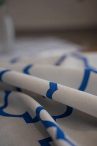 Macro detail of high-quality cotton linen fabric with blue trellis geometric patterns