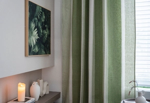 Detailed texture of green and beige striped linen curtains in a modern home interior