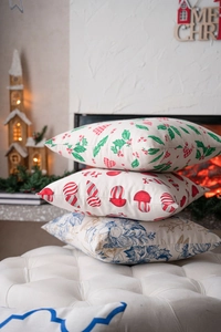 Detailed close-up of festive Christmas cushion covers with holly and floral prints