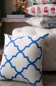 Detail of blue Moroccan trellis pattern on a white linen square throw pillow cover