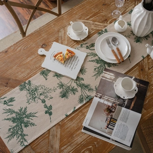 Beige cotton linen table runner with green pine branch prints and decorative tassels