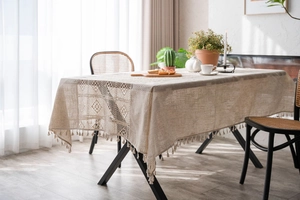 Close-up of bohemian tablecloth showing hollow crochet lace and handmade fringe details