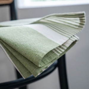 Green and white striped cotton linen kitchen curtain with textured fabric in a home setting