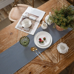Blue and white striped table runner in cotton linen style for modern dining room decor