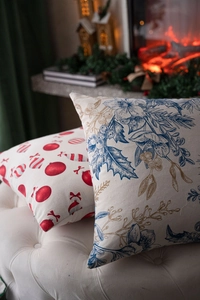 Detail of Christmas festive pillow covers with holiday patterns in a warm home setting