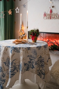 Detail of ruffle edge cotton linen tablecloth with vintage botanical pinecone print