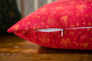 Close-up of invisible white zipper detail on a festive red Christmas cushion cover
