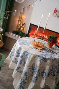 Detail of pinecone floral print tablecloth with elegant ruffled edge for holiday decor