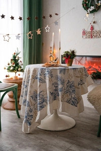 Close-up of elegant ruffles and festive floral patterns on a heavy cream table cover