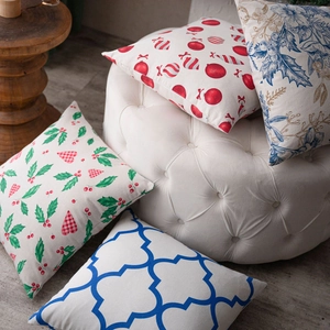 Set of four decorative Christmas pillow covers with festive floral and geometric patterns