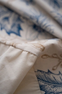 Macro shot of American pine cone leaf print tablecloth with ruffles and fine stitching