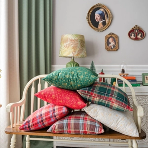 Green and red Christmas plaid pillow covers with snowflake patterns for festive sofa decor