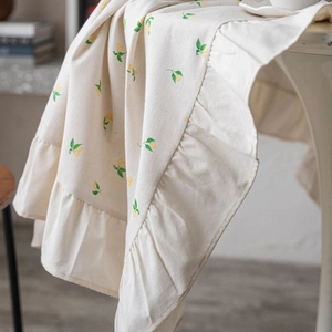 Elegant cream tablecloth with lemon print and ruffled edges for home dining decor