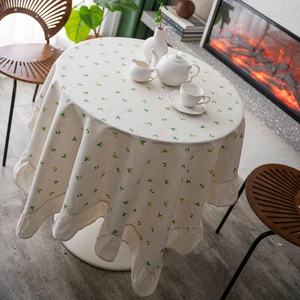 Floral round tablecloth with ruffled edges in a cozy French country home setting