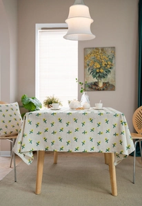 Detail of floral embroidery on cotton linen tablecloth with matching cushion