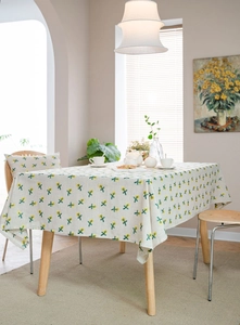 Close-up of linen tablecloth with yellow floral embroidery in a warm home setting