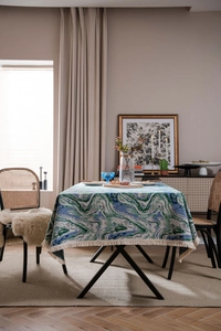 Detail of green ink marble pattern jacquard tablecloth with elegant white tassels