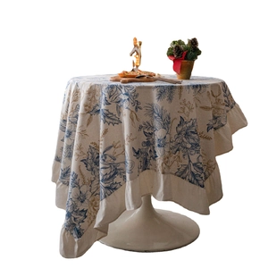 Round tablecloth with blue botanical pinecone print and elegant ruffled edges