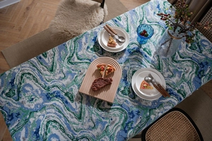 Detailed view of thick woven fabric with green fluid ink art and marble pattern texture