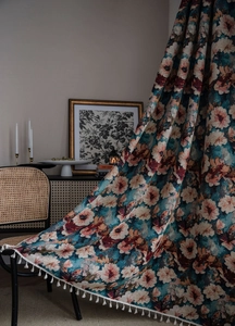 Detailed view of vintage floral jacquard fabric with elegant white tassel fringe