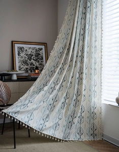 Macro detail of retro leaf print curtain with elegant beige tassels on textured cotton linen