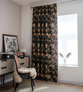 Detail of vintage floral jacquard curtain with white fringe trim for elegant home decor