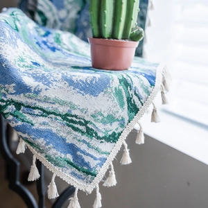 Macro detail of landscape jacquard fabric texture with decorative white cotton tassels