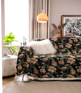Detail of vintage floral jacquard sofa throw with thick weaving and elegant fringe