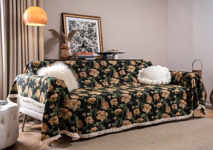 Detail of vintage floral sofa cover with yellow rose jacquard and delicate fringe trim