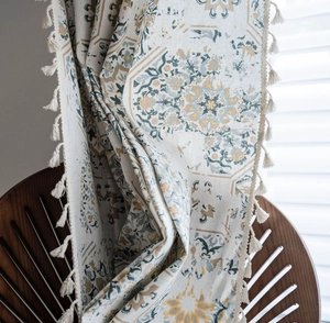 Detail of bohemian cotton linen curtain with vintage mandala pattern and white tassel trim
