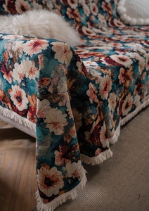Close-up of vintage floral jacquard fabric texture with white decorative fringes