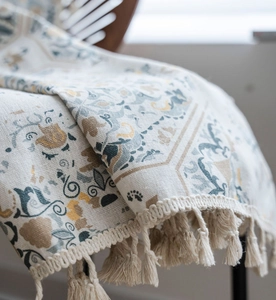 Detail of vintage mandala print on cotton linen fabric with handmade cotton tassels