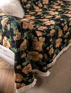 Close-up of vintage floral sofa cover with jacquard texture and decorative tassels