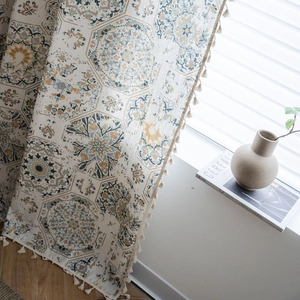 Linen cotton floral curtain with mandala patterns and tassel edge in natural window light