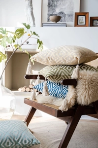 Detail of wave jacquard texture and cream tassels on colorful geometric cushion covers