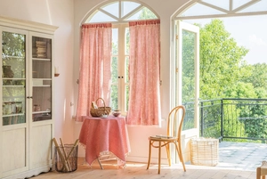 Red gingham cafe curtains and matching round tablecloth set in a rustic country interior