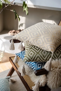 Detail of bohemian throw pillow covers featuring geometric patterns and handmade tassels
