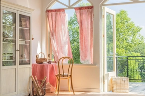 Red and white gingham short curtain and matching tablecloth in a bright rustic setting