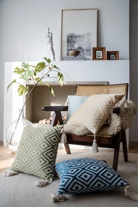 Close-up of geometric wave jacquard pillow case fabric with corner tassel details