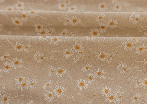 Detail of daisy print fabric showing weaving texture and soft folds on beige linen curtains