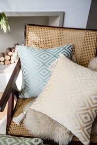 Close-up of geometric jacquard pillow covers with stylish fringe tassels and diamond pattern