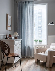 Detailed texture of blue geometric pattern curtain with cream tassels in a boho style home