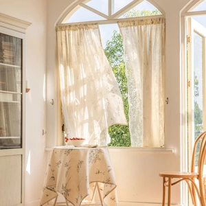 Elegant semi-sheer grey floral print curtains on an arched window for home decor