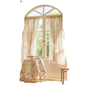 Floral print gray curtains and matching tablecloth set in a cozy home setting