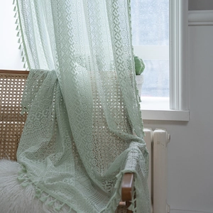 Green crochet lace curtain with geometric flower cutouts and tassel fringe for balcony